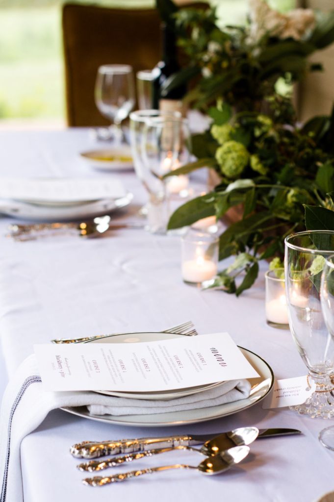 elegant table setting with white table cloth and menus