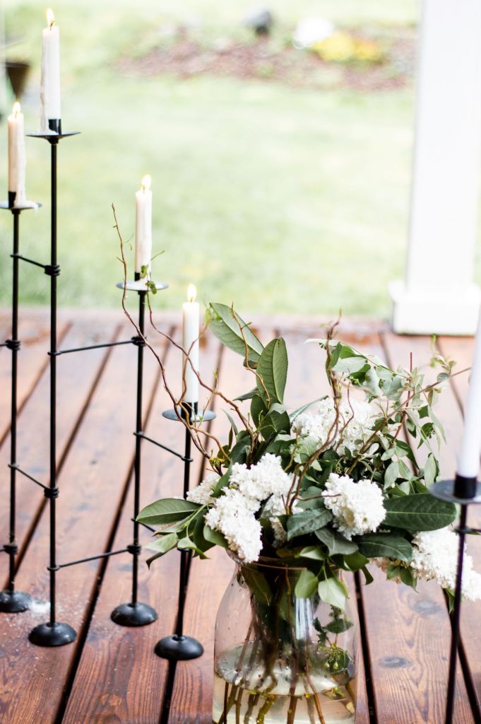 large vase of white lilacs and greenery